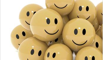 Pile of yellow smiley faces on a white background