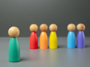 Colorful wooden people stand together in a line