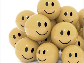 Pile of yellow smiley faces on a white background