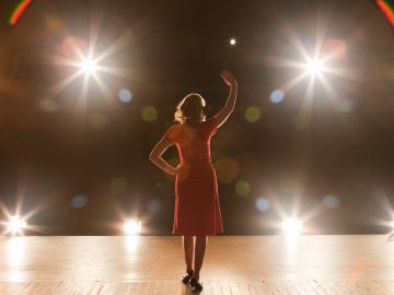 woman standing on stage