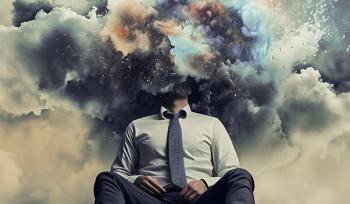 A person sits on the ground in the desert with storm clouds around their head