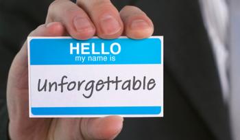 A hand holds up a name tag that says, "Hello, my name is unforgettable."