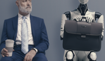 man sitting next to a robot