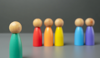 Colorful wooden people stand together in a line